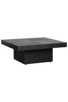 a black square table sitting on top of a white wall