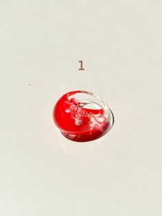 a red object sitting on top of a white surface