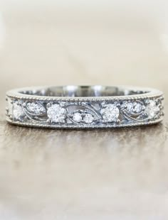 an antique style wedding band with diamonds