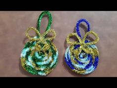 two small ornaments made out of beads on a table