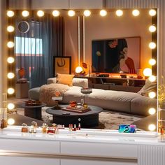 a living room filled with furniture and lots of lights on the wall above it's mirror