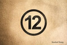 the number twelve in a circle on top of a brown paper