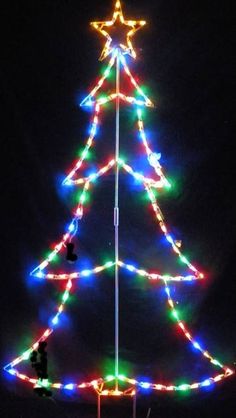 a lighted christmas tree on top of a pole