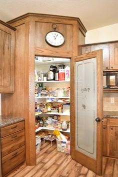 an open pantry with a clock on the wall