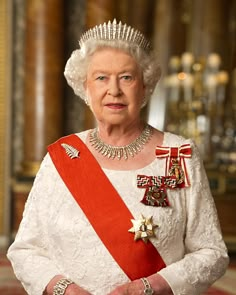 an older woman wearing a tiara and holding a red ribbon