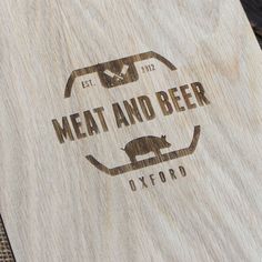 a wooden cutting board with the words meat and beer engraved on it's side