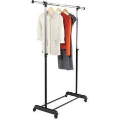 a garment rack with three shirts hanging on it