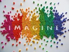 the word imagine written in rainbow colors on a white background with crocheted letters