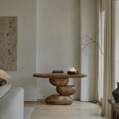 a living room with a couch, coffee table and candles on the tables in it