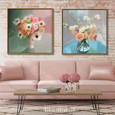 two paintings on the wall above a pink couch and coffee table with flowers in it