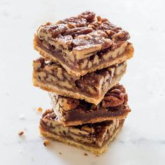 three pieces of pecan bar stacked on top of each other