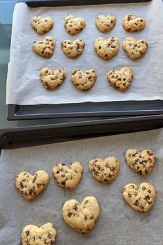 chocolate chip cookies are arranged on parchment paper in the shape of heart - shaped hearts