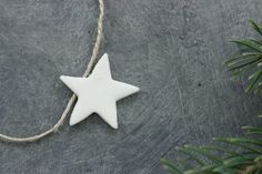 a white star ornament hanging from a string