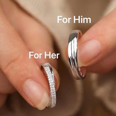 two women's hands holding wedding rings with the words for him and her written below