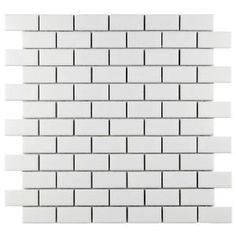 a white brick wall that is made out of several different sized tiles, with black and white lines on each side