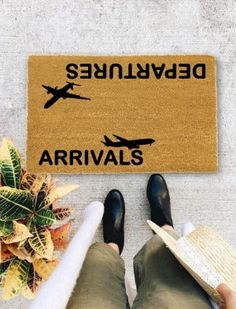 someone is standing in front of a door mat with an airplane on it that says devilsen arrivals