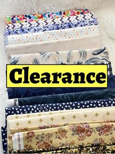 there are many different types of fabrics on this table top with the words clearance over them