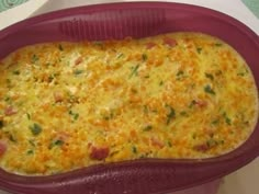 a casserole dish with meat and cheese in it sitting on a white table