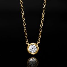 Ross-Simons - .15ct Bezel-Set Lab Grown Diamond Necklace Over Sterling. 16". Impressive sparkle, incredible price. On our classic necklace, a .15 ct. t. w. round brilliant-cut lab-grown diamond shines from a sleek bezel setting stationed on an 18kt yellow gold over sterling silver cable chain. Lab-grown diamonds are identical to mined diamonds according to their optical, physical and chemical properties. Springring clasp, lab-grown diamond necklace. Diamond birthstones are the perfect gift for A Classic Yellow Gold Solitaire Necklace In Sterling Silver, Classic Gold Necklace With Bezel Setting, Classic Gold Diamond Necklace With Vvs Clarity, Dazzling Yellow Gold Necklace With Single Diamond, Dazzling Yellow Gold Necklaces With Single Diamond, Yellow Gold Necklaces With Vvs Clarity For Anniversary, Anniversary Yellow Gold Necklace With Brilliant Cut, Classic Gold Necklace With Brilliant Cut, Classic Round Pendant Necklace For Anniversary