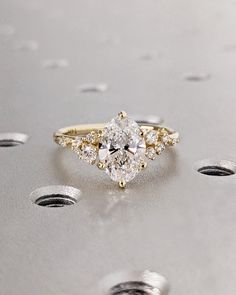 a close up of a diamond ring on a surface