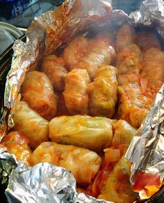 some food is wrapped in tin foil and ready to be cooked on the stove top