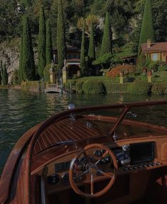 there is a boat in the water with trees around it and houses on the other side