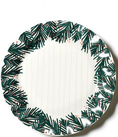 a green and white plate with pine branches on it