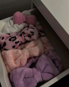 a drawer filled with blankets and stuffed animals