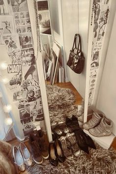 there are many pairs of shoes on the floor in front of a mirror with lights