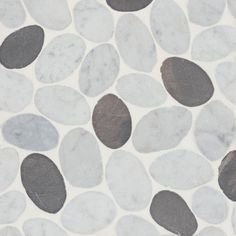 a white and grey tile with black circles on it's surface is shown in close up