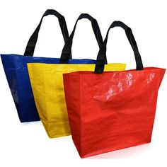 three different colored bags with black handles