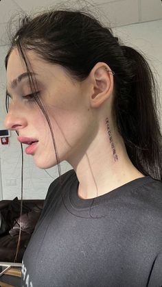 a woman with a tattoo on her neck