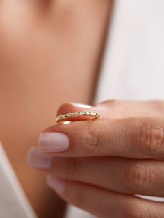 a woman's hand with a gold ring on it