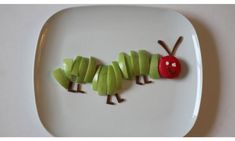 the very hungry caterpillar is made out of apple slices on a white plate