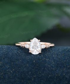 an engagement ring with a pear shaped diamond in the center