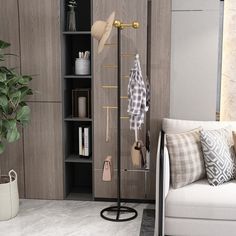 a white couch sitting next to a tall wooden book shelf filled with books and other items