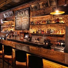 a bar with lots of bottles on the shelves