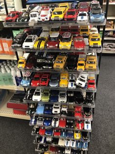 there are many toy cars on the shelves in this store that is filled with them