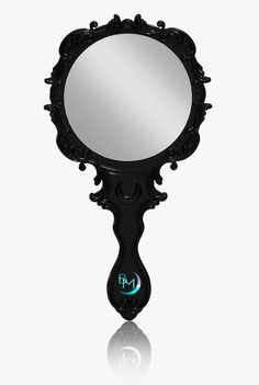 an ornate black mirror on a white background