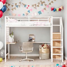 a loft bed with a desk underneath it and balloons in the air behind it,