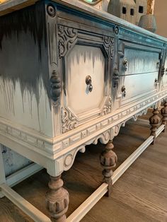 an old dresser is painted blue and white