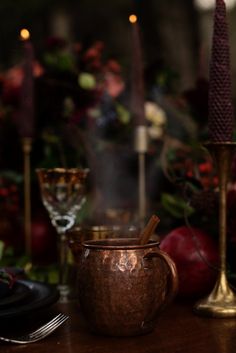 a table topped with candles and dishes filled with food