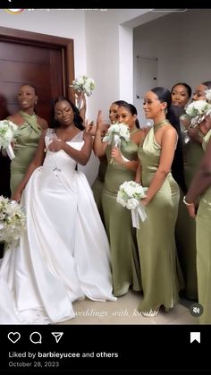 a group of women standing next to each other in front of a door holding bouquets