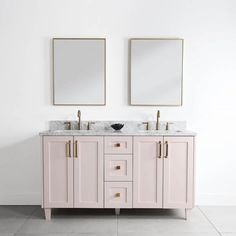 two mirrors are above the double sink vanity in this white bathroom with marble countertops