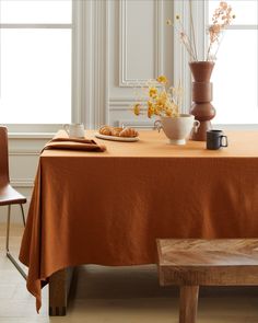 an orange table cloth is on top of a wooden bench