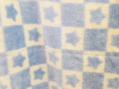 a blue and white checkered towel with an animal on it's back side