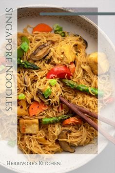 a white plate topped with noodles and vegetables