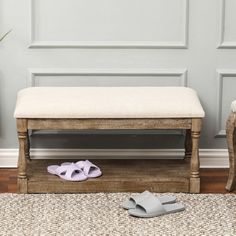 a pair of slippers sitting on top of a wooden bench next to a door