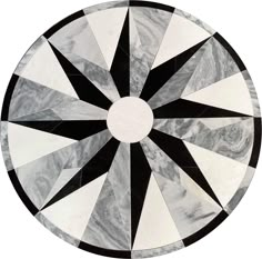 a circular marble table top with black and white designs