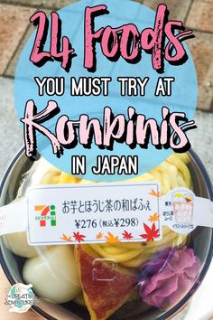 a bowl filled with lots of different foods on top of a wooden table next to a sign